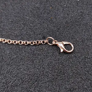 Rose gold jewelry chain detail with lobster clasp, perfect for DIY pendant and necklace parts.