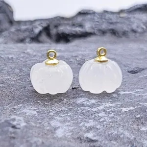 Detail shot of 13-14mm carved white jade pumpkin charm with gold loop for DIY jewelry.