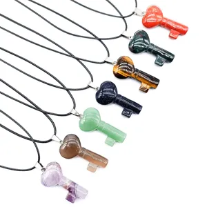 Natural crystal gemstone heart key pendant necklace detail showing various healing stones.
