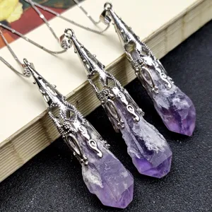 Close-up of natural amethyst crystal pendant necklaces with exquisite hollow metal caps.