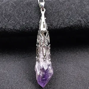 Natural amethyst raw stone pendant detail, ornate silver plated metal cap, jewelry close up