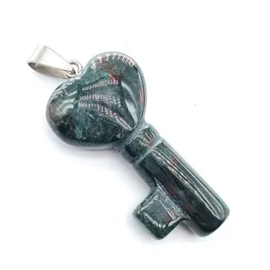 Natural stone heart key pendant detail, unique green gemstone necklace accessory.