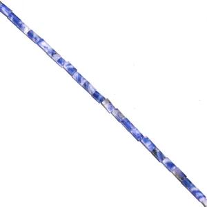 Close-up of blue and white stone tubular loose beads, perfect for DIY jewelry crafting.