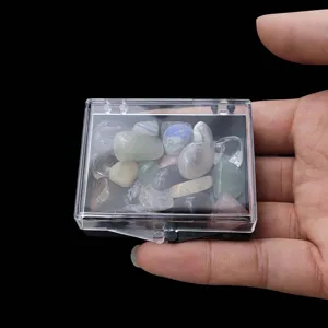 Nahaufnahme von bunten Edelstein Trommelsteinen in einer transparenten Plastikbox.