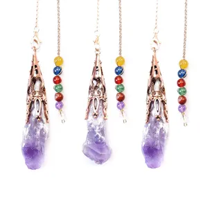 Close up view of natural amethyst crystal raw stone pendant with chakra beads and metal chain.