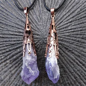 Raw amethyst crystal pendant detail view, showing unique purple stone texture and vintage bronze cap.