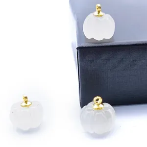 Detailed view of 13-14mm carved white crystal pumpkin pendant with gold bail for DIY jewelry.