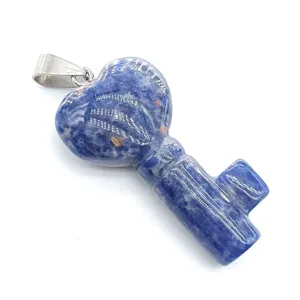 Blue stone key pendant detail showcasing natural crystal texture and heart shape top close-up.