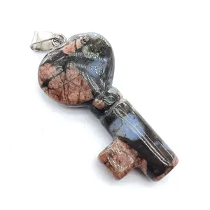 Close-up detail of natural crystal stone heart key pendant showing unique texture and bail.