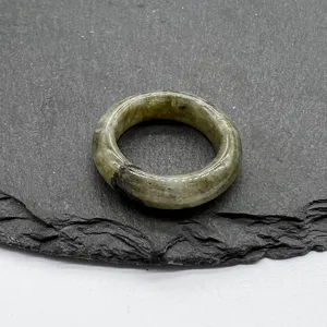 Detail shot of natural stone ring, vintage round mineral band for unique styling and daily wear.