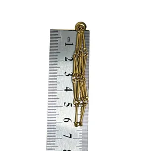 Gold plated bamboo joint chain pendant detail showing length with ruler for jewelry making.