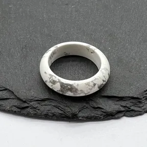 Detail view of white stone ring band with natural marble texture, minimalist unisex jewelry piece.