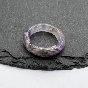 Close-up detail shot of natural purple crystal agate ring, elegant stone band jewelry.