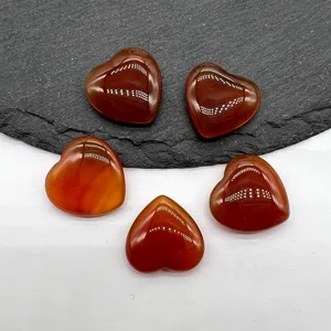 Detailed close-up of polished red crystal heart gemstones, smooth non-perforated crystal.