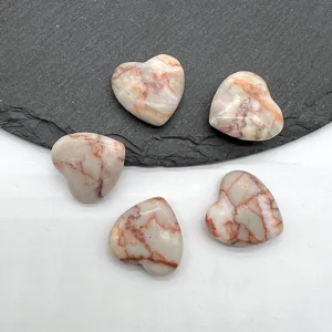 Natural crystal heart shaped gemstone craft, smooth polished pocket stone for home decor display.