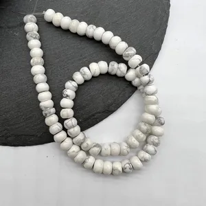 Close-up of natural white stone abacus spacer beads with smooth polished texture for DIY.