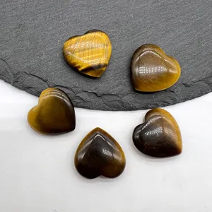 Detailed shot of polished tiger eye heart gemstone crystal decor, smooth surface, beautiful piece.