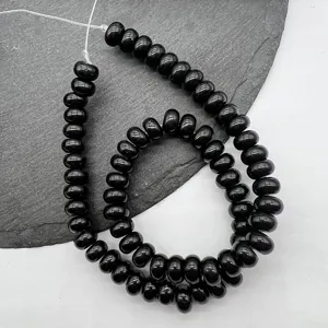 Detailed close-up of black abacus beads spacer strand, ideal for DIY jewelry making.