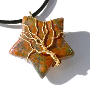Detail shot of star-shaped gemstone pendant with gold wire wrapped tree of life design on cord.