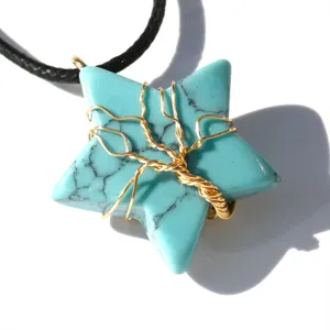 Detail view of a stunning star-shaped turquoise wire-wrapped tree of life pendant necklace.