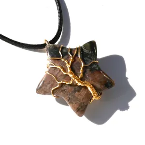 Natural crystal star pendant necklace with wire wrapped tree of life design and black cord.