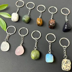 Detailed view of natural crystal tumbled stone keychains featuring various polished gemstones.