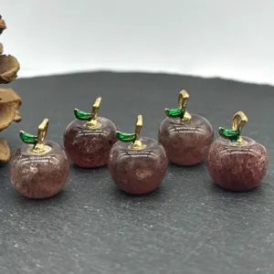 Details of natural crystal apple charms with gold stems and green leaves for DIY jewelry.
