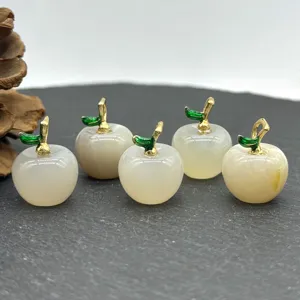 Detail view of 5 natural stone apple pendants with gold enamel leaf for DIY jewelry making.