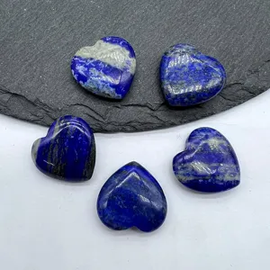Natural lapis lazuli heart shaped polished crystal gemstone detail close up view display.