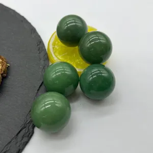 Polished dark green stone crystal spheres detail, smooth surface, decorative ornament.