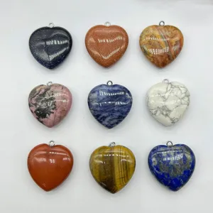 Close up of colorful heart shaped gemstone pendants assortment for necklace and keychain DIY.