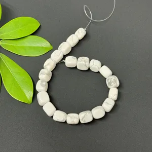 Close up detail of white irregular square loose beads for DIY jewelry making and crafting.