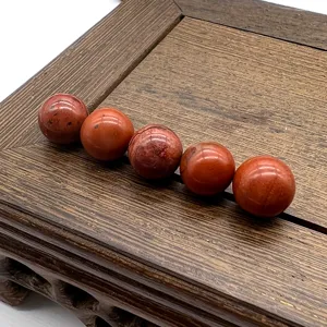 Red jasper gemstone loose beads detail, smooth round undrilled stone for DIY jewelry making.