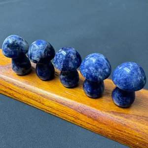 Detail view of polished blue stone mushroom figurines, natural crystal mineral ornament set.