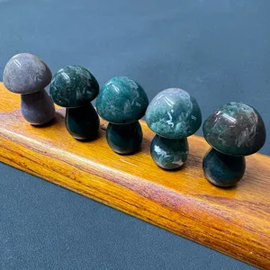 Detail view of natural crystal carved stone mushrooms displayed neatly on a wooden stand for decor.