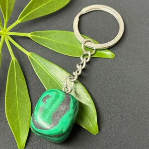 Detailed close-up shot of the natural malachite tumbled stone keychain with stainless steel ring.