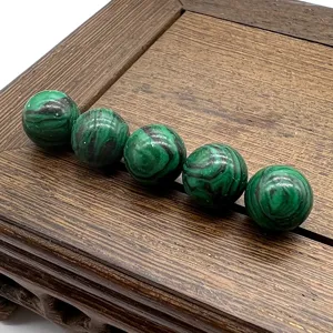 Close-up detail shot of 10mm round gemstone beads arranged on a wooden tray for DIY crafts.
