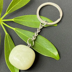 Close-up detail of the natural green crystal tumbled stone pendant and stainless steel ring.
