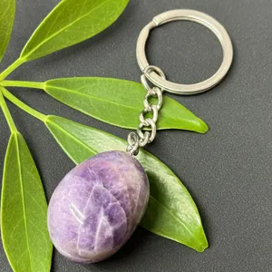 Close-up detail of natural amethyst tumbled stone keychain with stainless steel ring for keys.