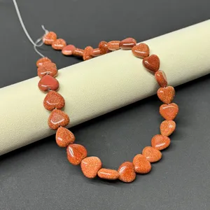 Heart-shaped goldstone bead strands for DIY jewelry making, ideal for custom bracelet design.