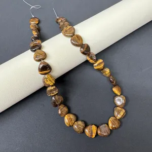 Close-up detail of natural stone heart beads, showcasing polished texture and unique patterns.