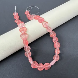 Close-up detail of 12mm natural stone heart beads strand for DIY jewelry making and bracelet design.