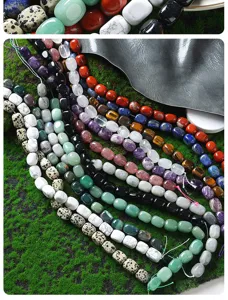 Close-up display of various natural gemstone rectangular beads, colorful DIY jewelry accessories.