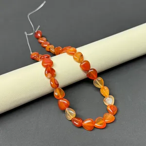 Close-up detail of natural gemstone heart-shaped agate beads for DIY jewelry making.