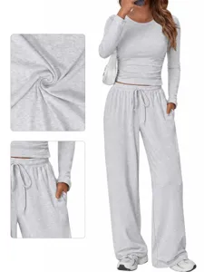 Close-up detail showing the soft fabric texture and pocket of the grey lounge set.