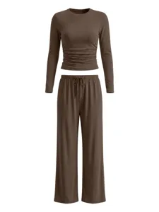 Brown long-sleeve crop top featuring side ruched details and matching wide-leg drawstring pants.