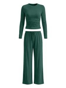 Dark green long sleeve loungewear set with ruched top and wide leg pants for women.