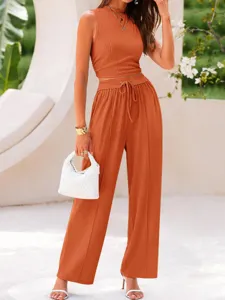 Solid ribbed two-piece set featuring a slim crop top and high waist wide leg pants detail.
