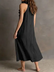 Detail view of a black sleeveless linen maxi dress with ruffle hem, elegant style.