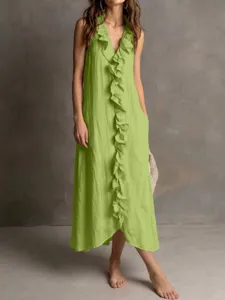 Detail shot of green sleeveless V-neck cotton linen dress featuring front ruffles and large hem.
